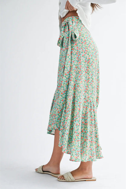 Floral skirt worn by a person on a white background
