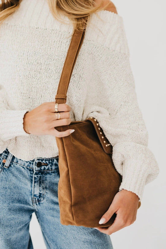 person holding suede bag