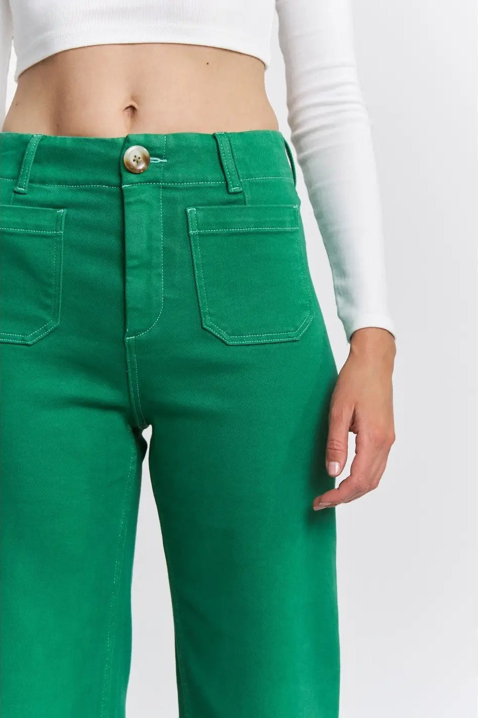 Green pants worn by a person on a white background