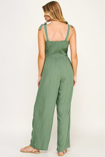 Woman wearing a green jumpsuit on a white background