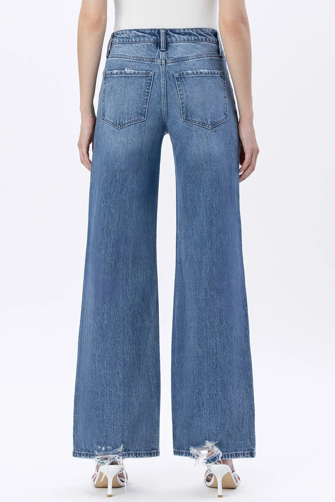 Blue jeans worn by a person on a white background