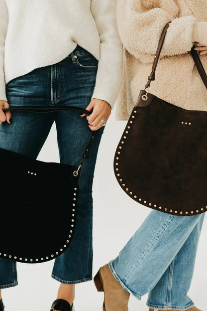people holding hobo bags
