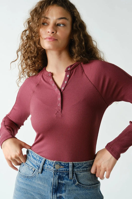 woman in henley long sleeve top and jeans
