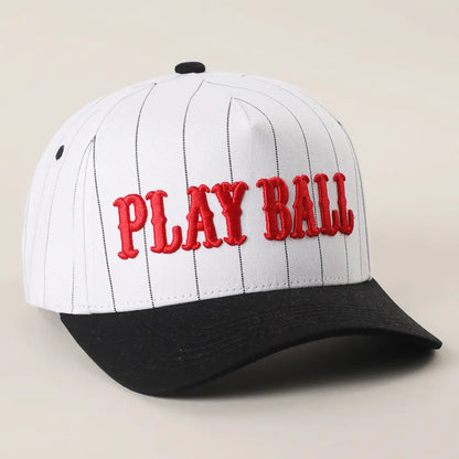 Baseball cap with 'PLAY BALL' text on a beige background