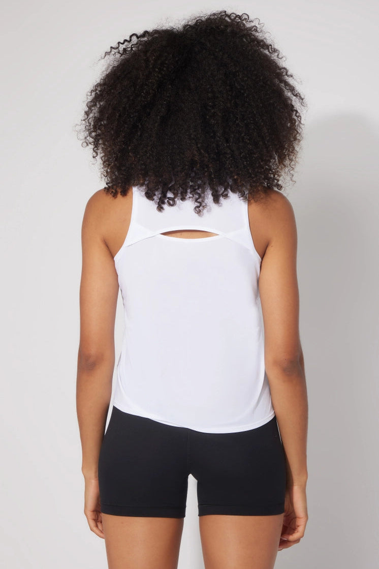 backside of woman wearing white tank top and black shorts