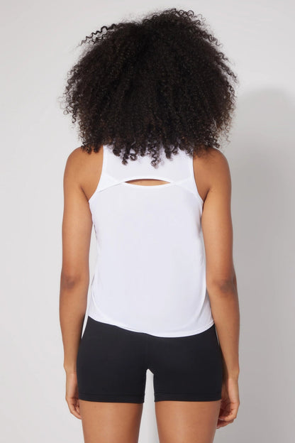 backside of woman wearing white tank top and black shorts
