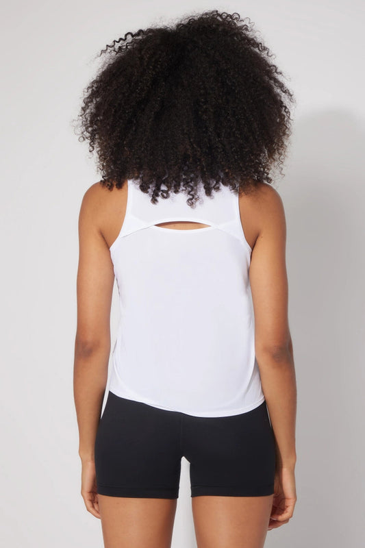 backside of woman wearing white tank top and black shorts