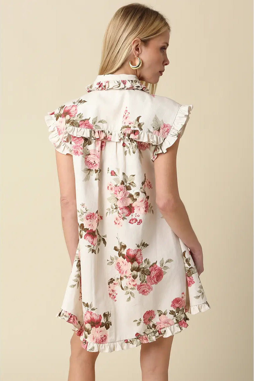 Woman wearing a floral dress against a beige background