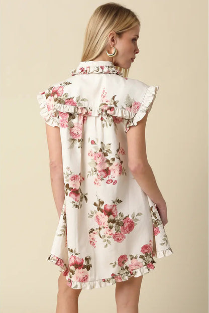 Woman wearing a floral dress against a beige background