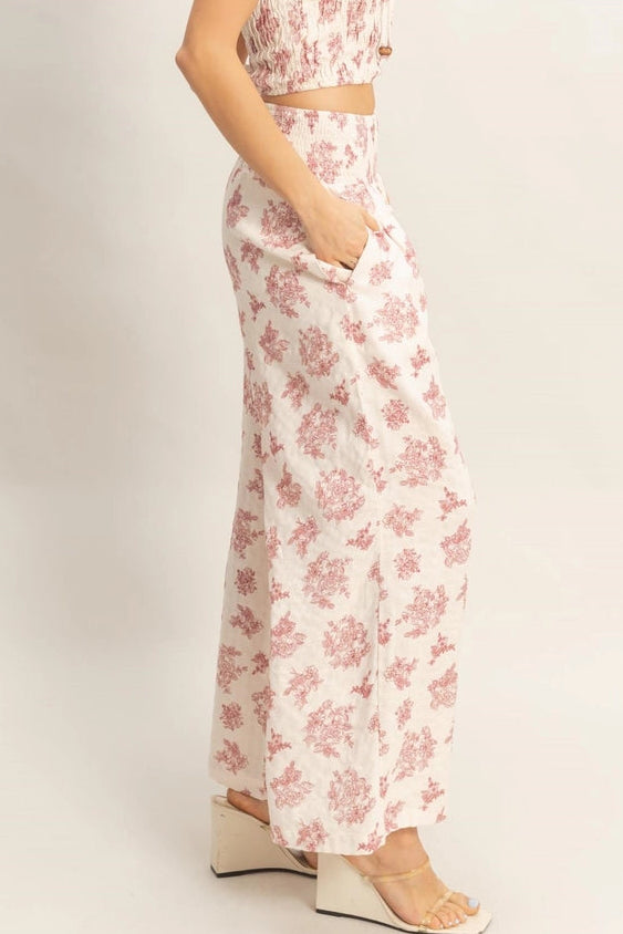 Woman wearing a floral two-piece outfit on a plain background