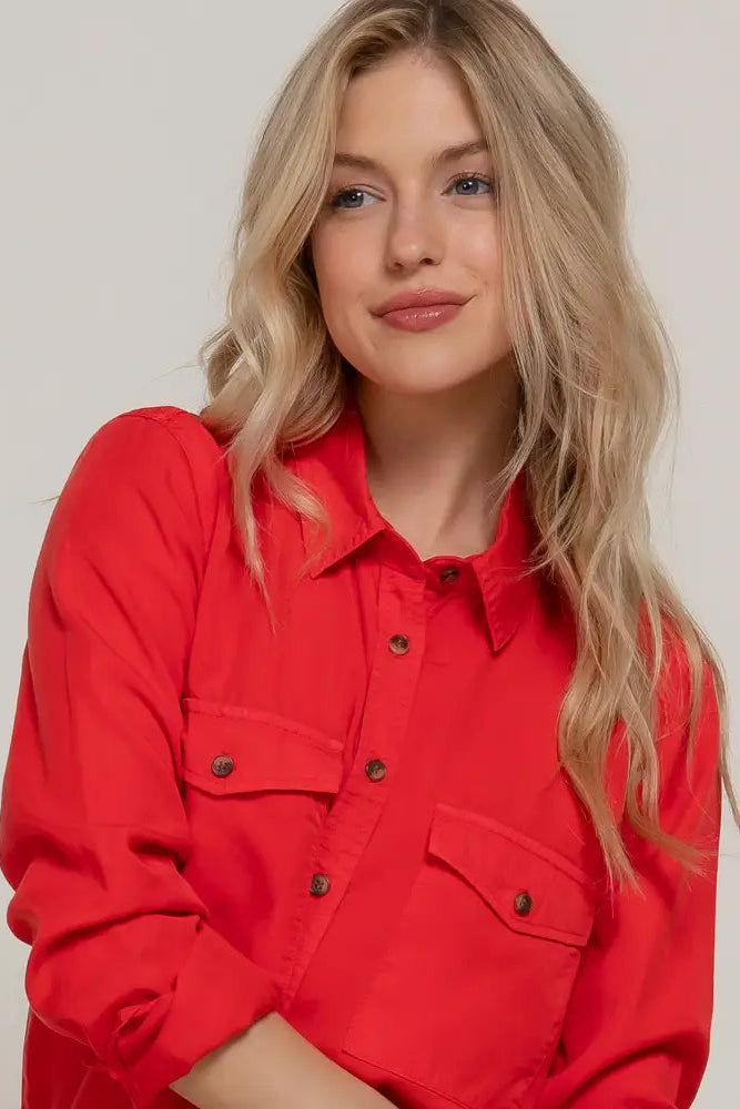 Woman wearing a red jacket against a plain background