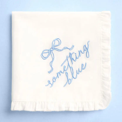 White blanket with blue text 'Something Blue' on a light blue background