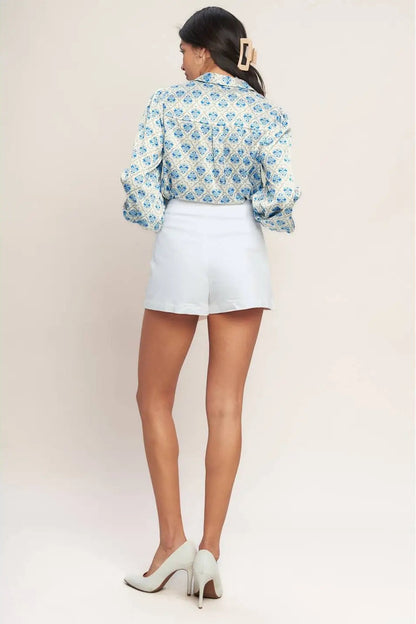 back view of woman wearing blouse with white skort 