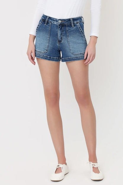 Person wearing blue denim shorts on a white background