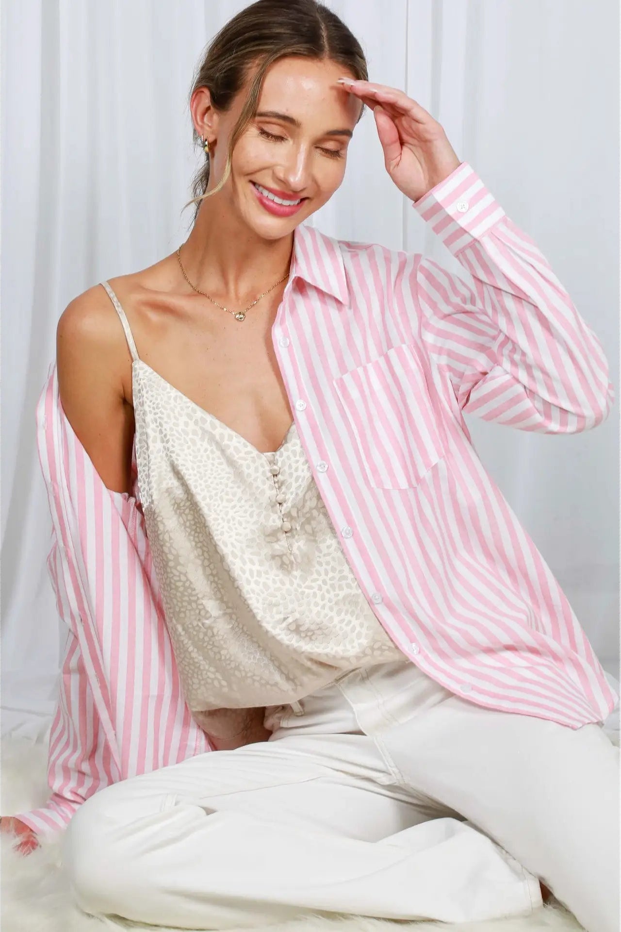 woman wearing striped button up with jeans 