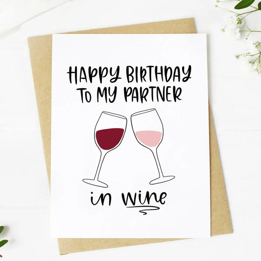 Birthday card with wine glasses and text 'Happy Birthday to my partner in wine' on a white background.