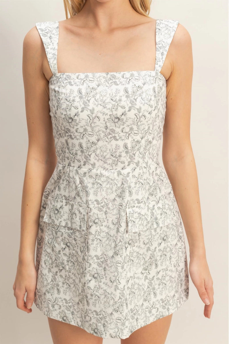 White floral dress worn by a model on a beige background