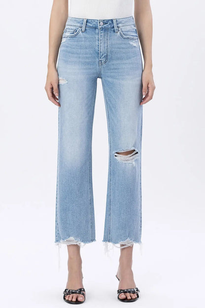 Light blue distressed jeans worn by a person on a white background