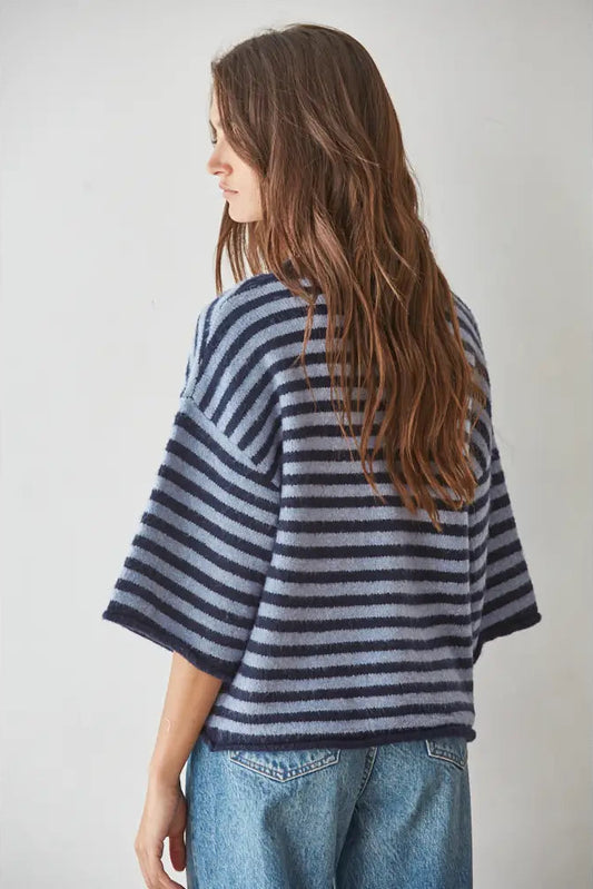 back of woman in blue striped sweater