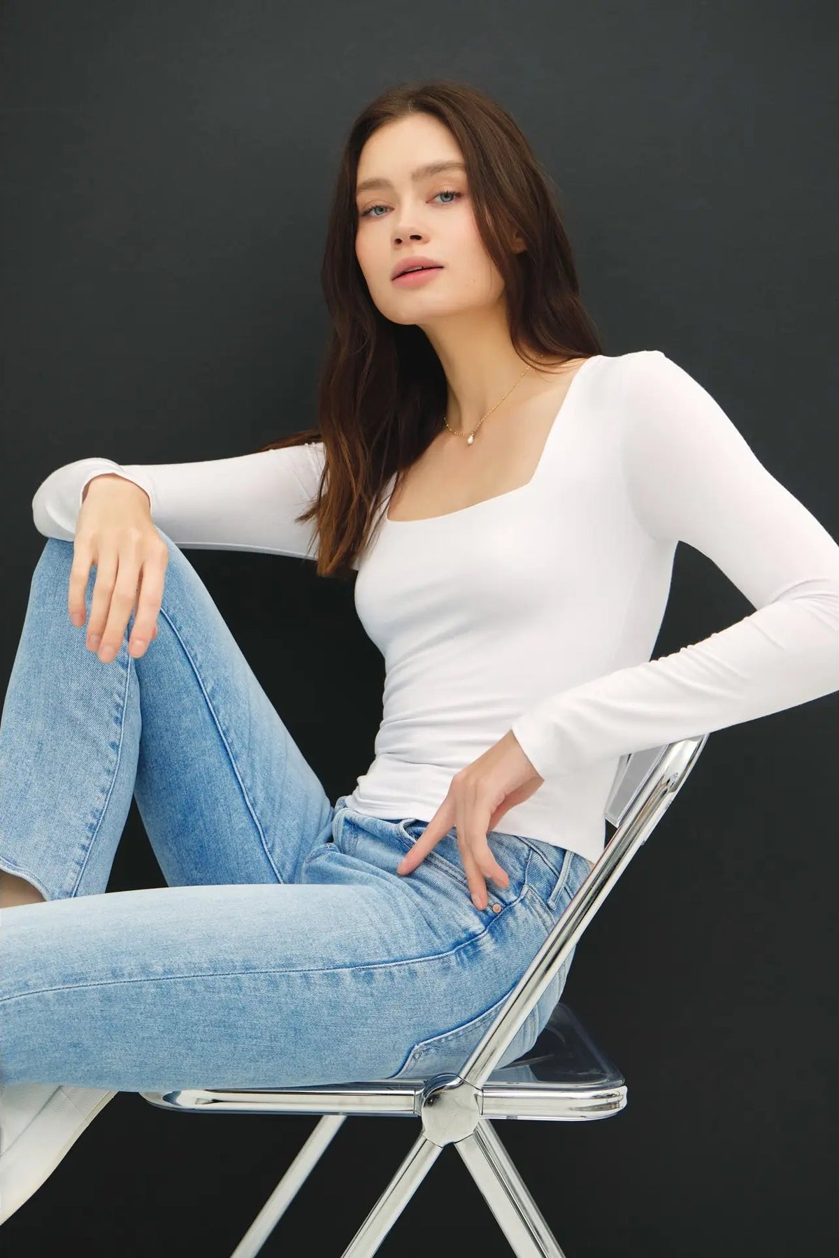woman wearing square neck long sleeve top with jeans