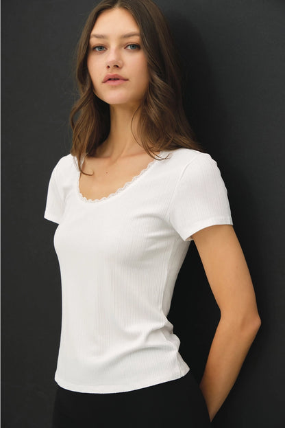 Woman wearing a white t-shirt against a black background