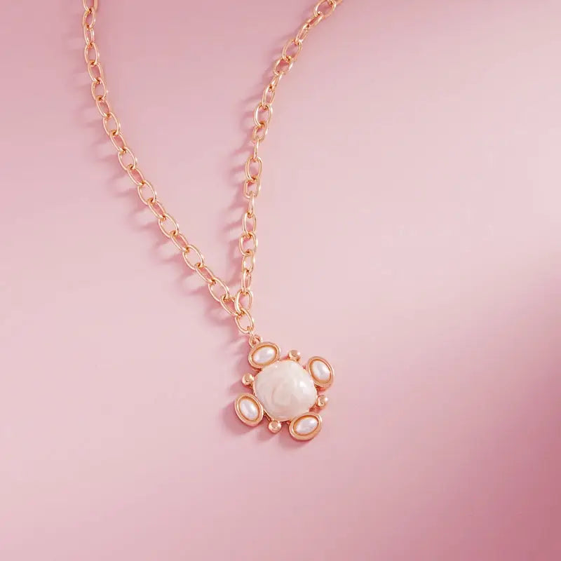 Necklace with a heart-shaped pendant on a pink background