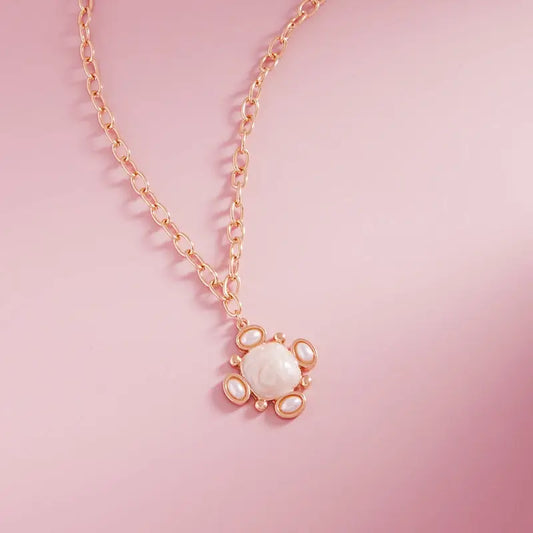 Necklace with a heart-shaped pendant on a pink background