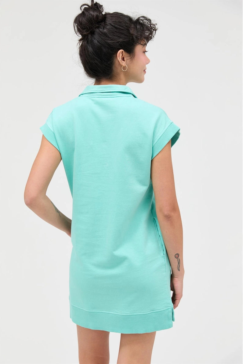 Person wearing a turquoise dress on a white background