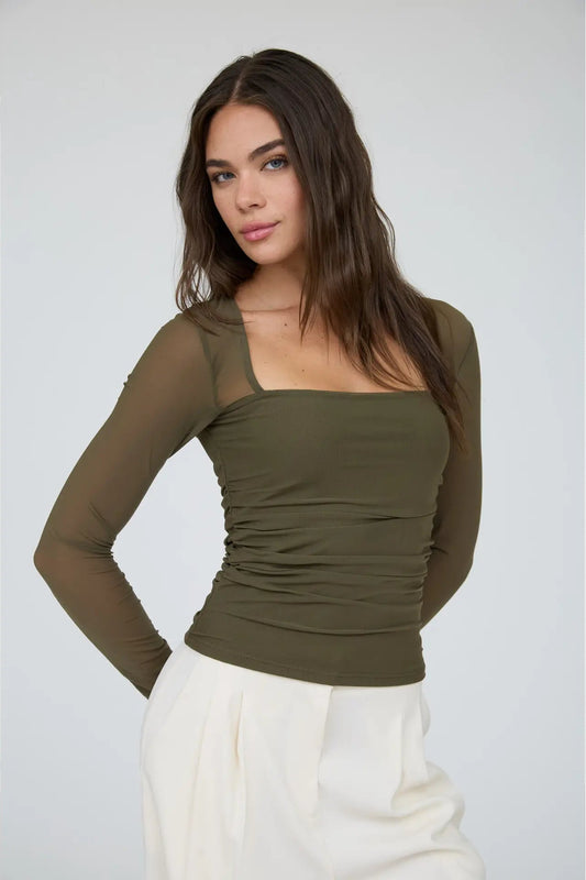 woman in ruched long sleeve top