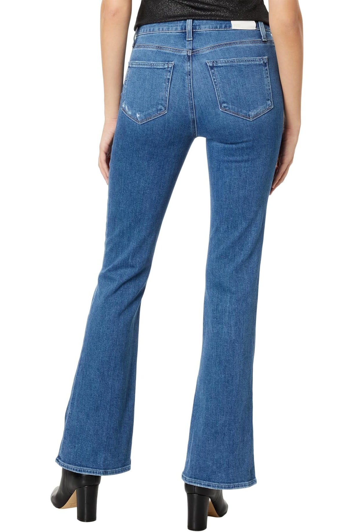 Blue jeans worn by a person on a white background
