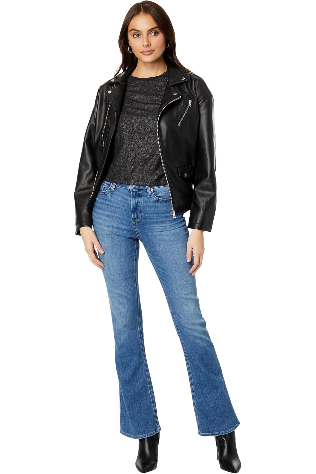 Woman wearing a black leather jacket, gray shirt, and blue jeans on a white background