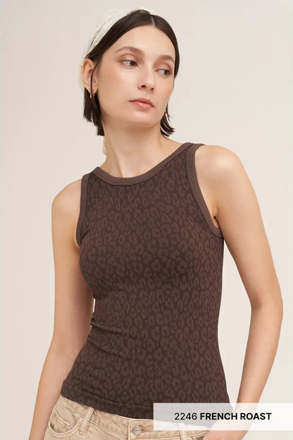 A woman wearing a dark brown ribbed tank top with a subtle tonal animal print pattern, paired with light beige jeans and a white headband. A text overlay at the bottom right reads '2246 FRENCH ROAST'.