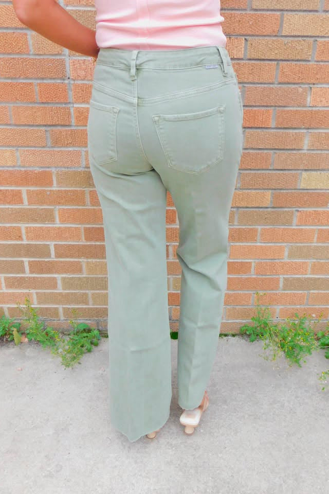 back view of person wearing sage green jeans 