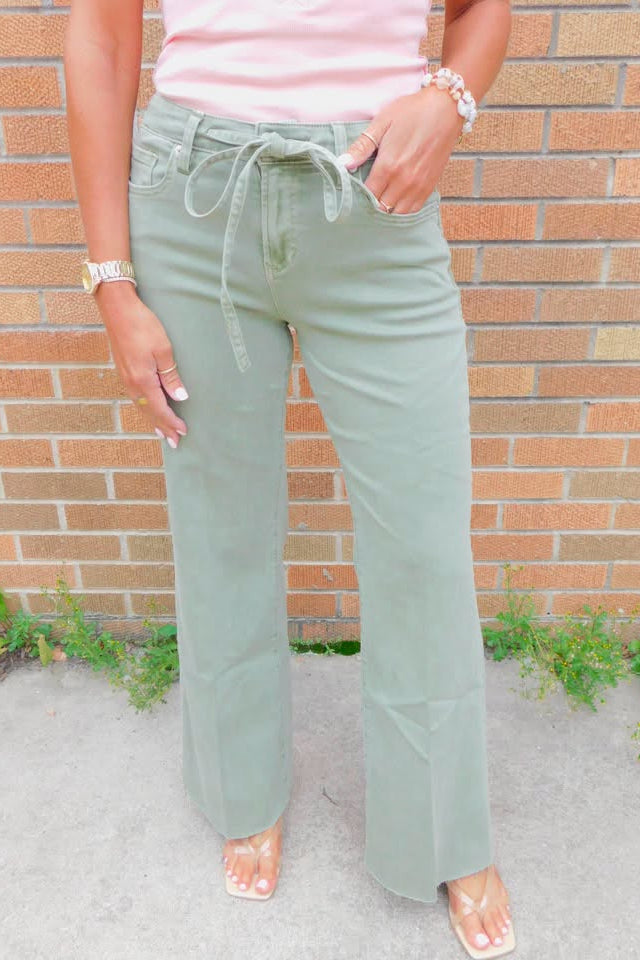 person wearing sage green jeans