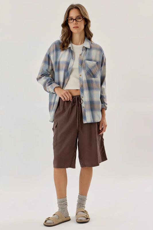 woman in button down shirt and shorts