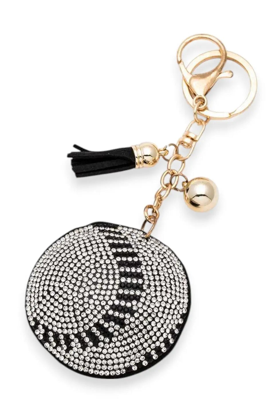 Keychain with black and white round embellished charm and tassel on a white background