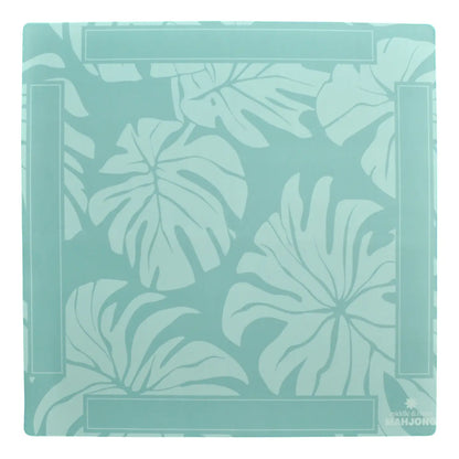 A square decorative tile or coaster featuring a tropical monstera leaf pattern in shades of mint green and light teal, with a subtle border design and the 'ARJON' brand logo in the bottom right corner.