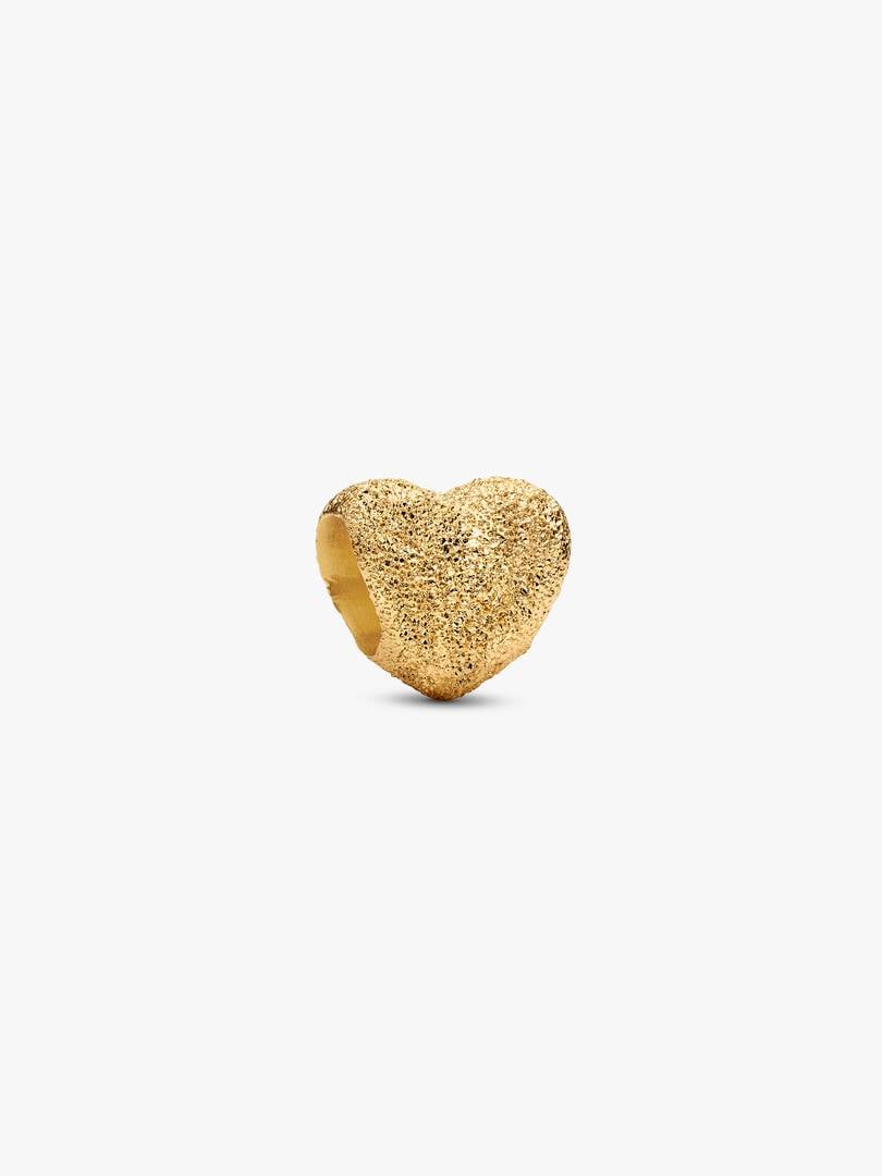 Gold heart-shaped ring on a white background