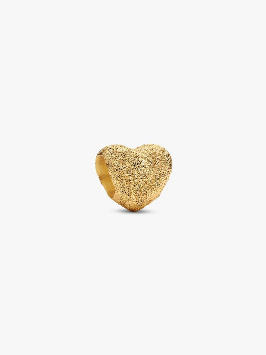 Gold heart-shaped ring on a white background