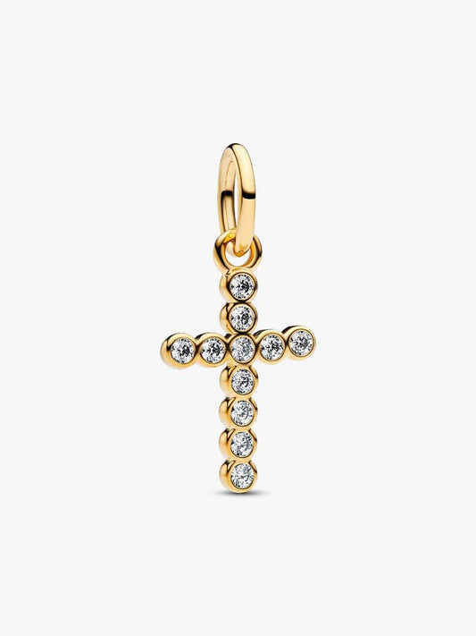 Gold cross pendant with embedded stones on a white background