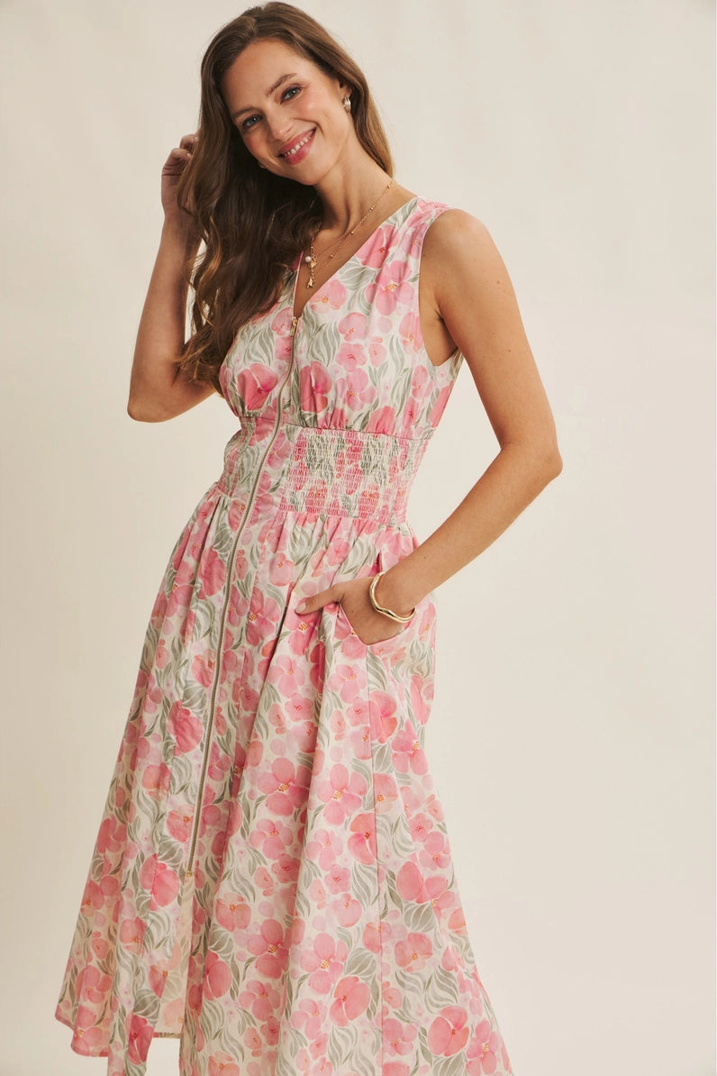 Woman wearing a floral dress on a plain background