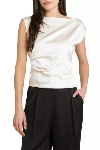 A woman wearing a white draped satin top with cap sleeves and black wide-leg trousers, shown from the chin down against a plain white background.