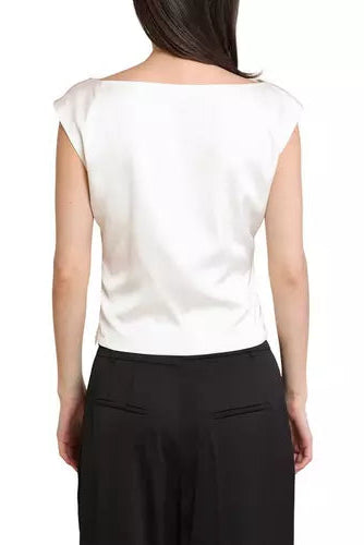 A woman shown from the back wearing a white boat-neck top and black trousers against a plain white background.