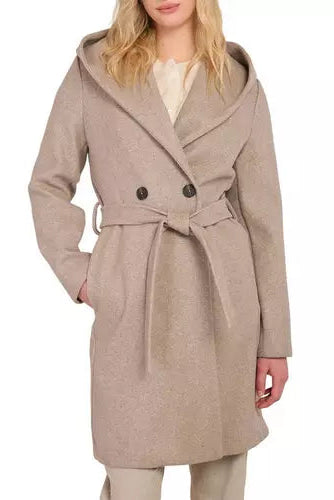 A woman wearing a light beige hooded wrap coat with a tie belt and dark buttons, shown against a plain white background.