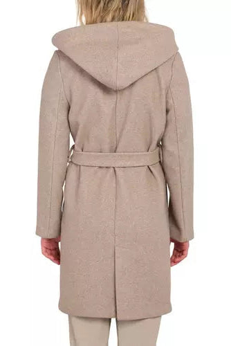 A woman viewed from the back wearing a hooded belted coat in a light taupe-beige color, paired with matching beige pants, against a plain white background.