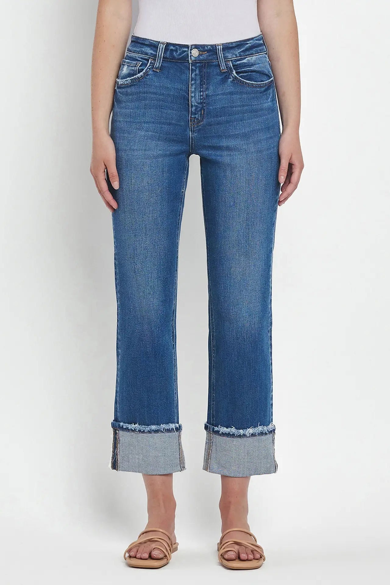 Blue jeans worn by a person on a white background