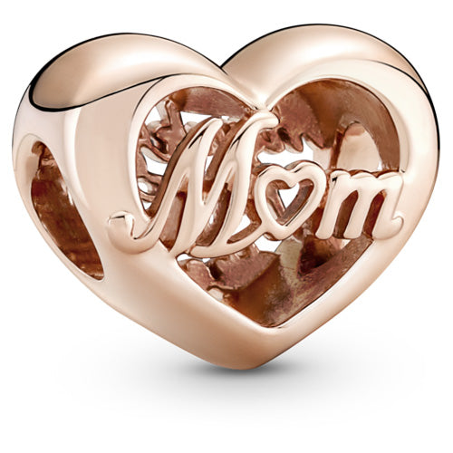 A heart-shaped rose gold charm with the word 'Mom' in cursive script across the front, set against a clean white background.