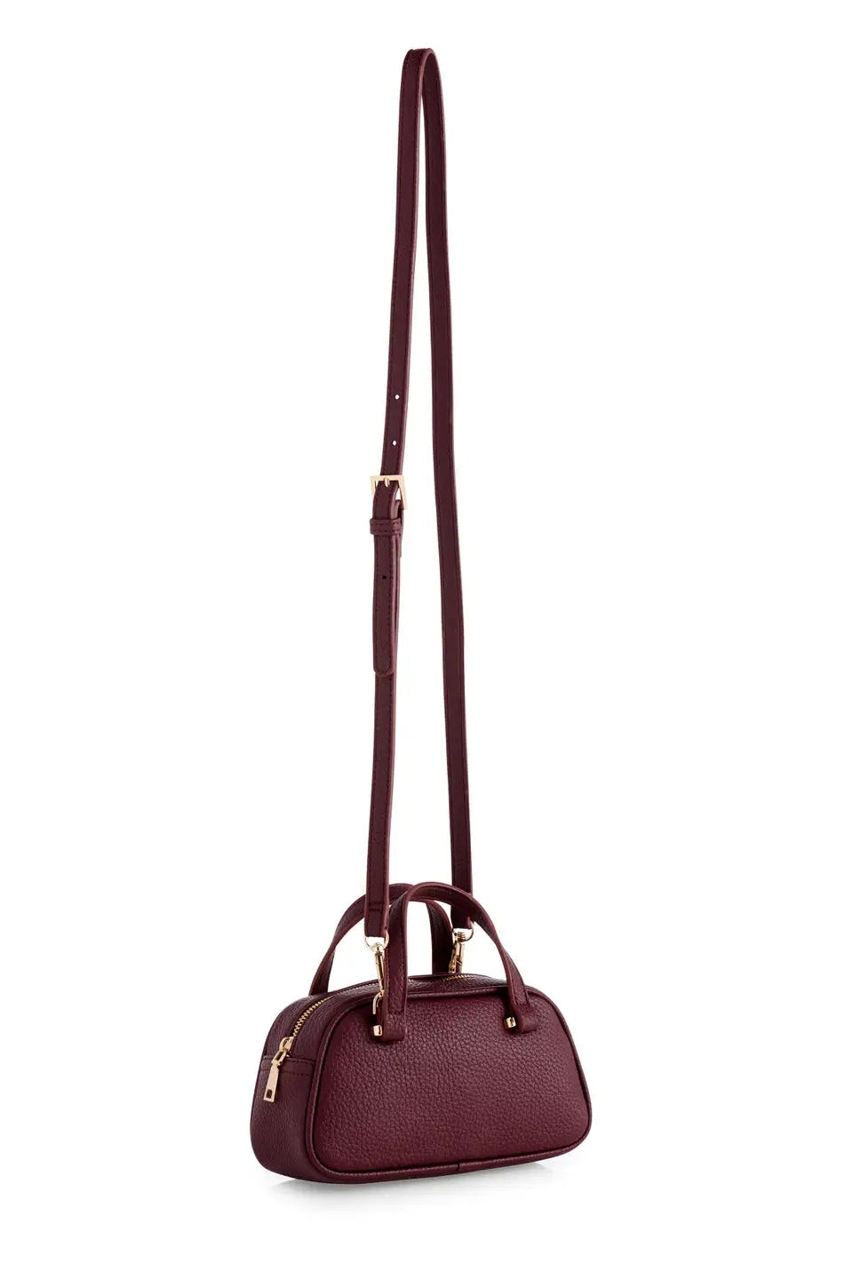 A burgundy pebbled leather crossbody handbag with a long adjustable shoulder strap, dual top handles, and gold-tone hardware, shown against a plain white background.