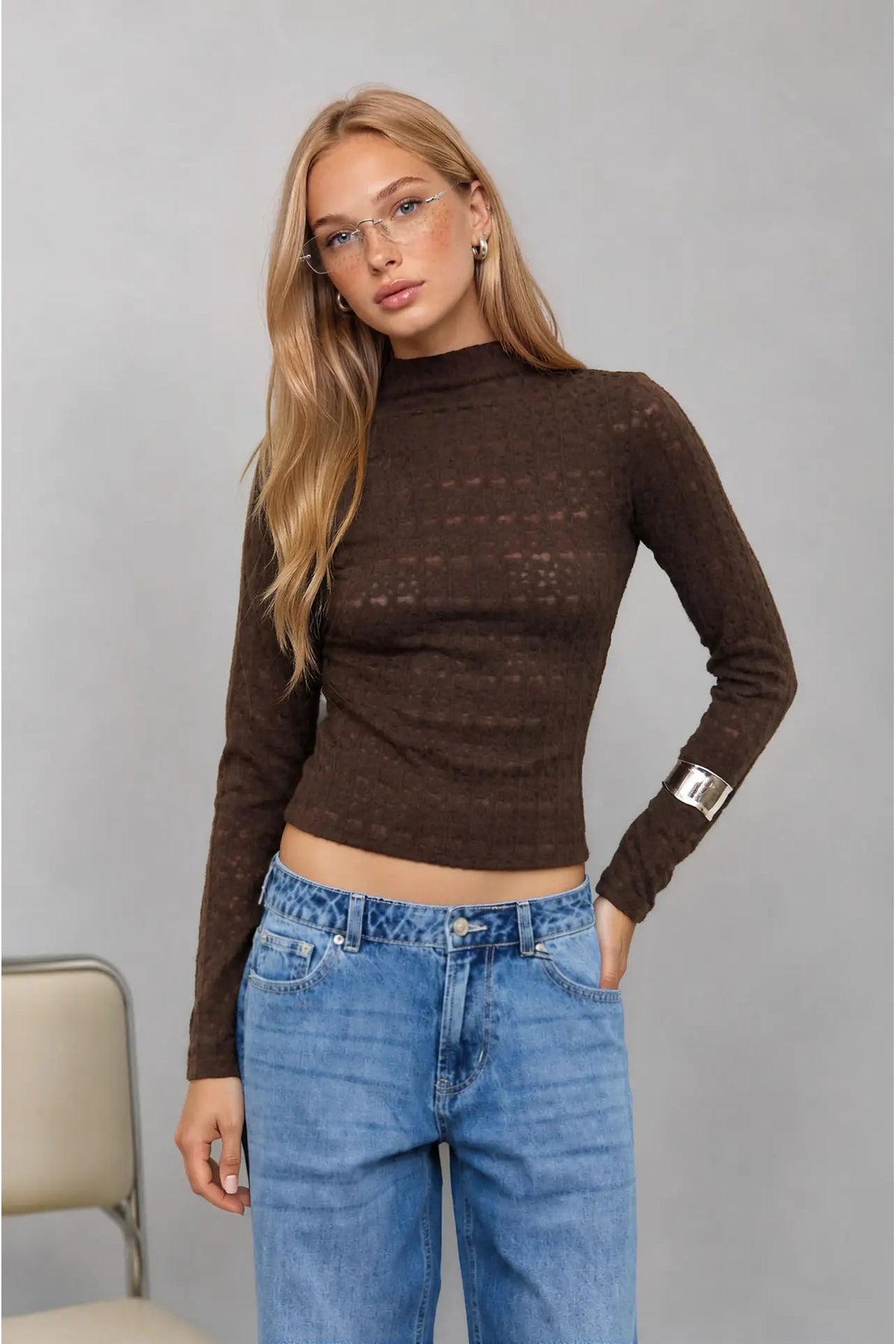 woman in mock neck top and jeans