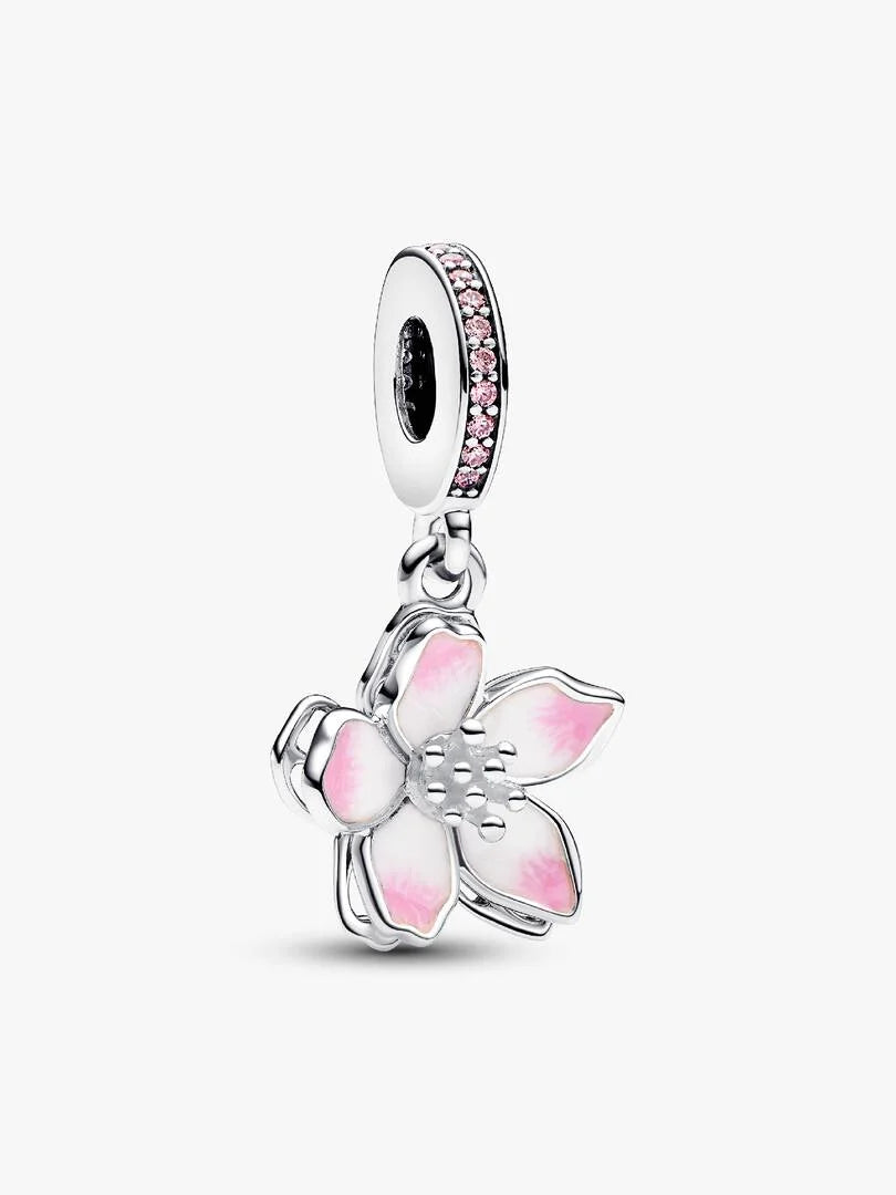 Silver charm with pink floral design on a white background